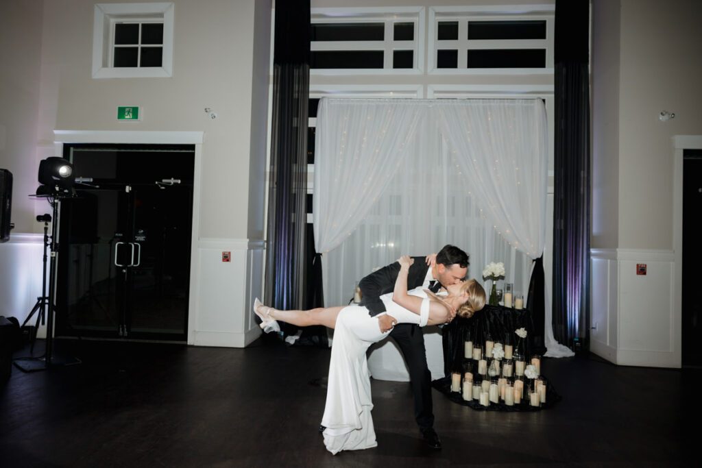 Bride and groom sharing their first dance under twinkle lights during their timeless, elegant wedding reception in Saskatoon.