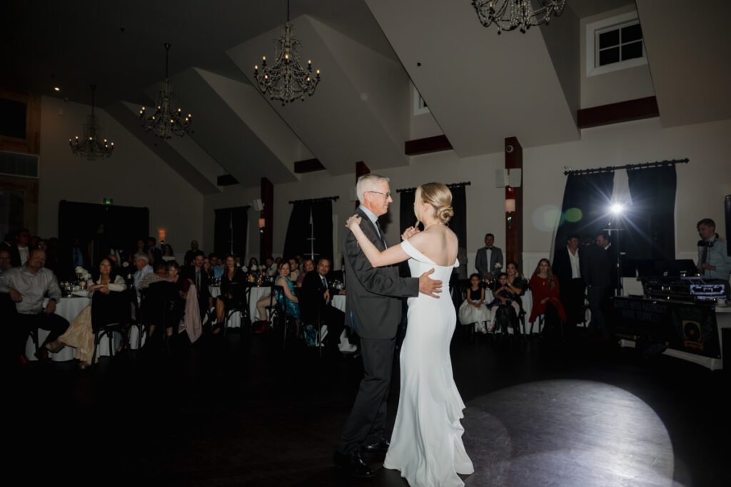 Emotional moment as the bride shares a slow dance with her father during a heartfelt reception celebration.