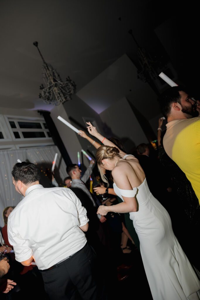 Lively reception dance floor at The Glen at Crossmount, filled with guests laughing, spinning, and celebrating with the newlyweds.