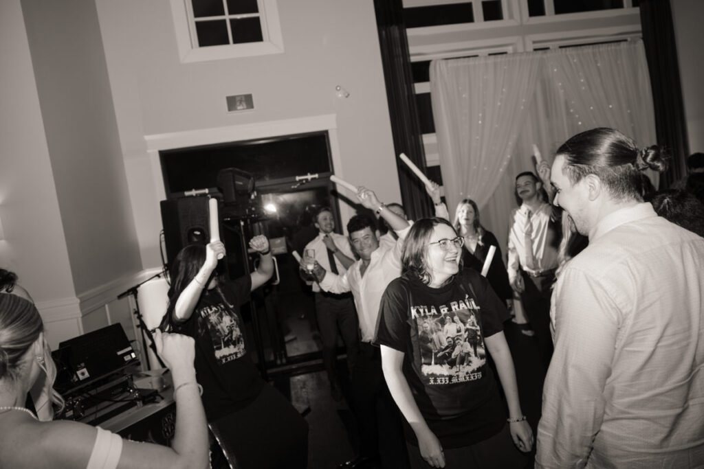 Guests forming a circle around the newlyweds for a high-energy dance party under twinkling lights at a romantic Saskatoon venue.