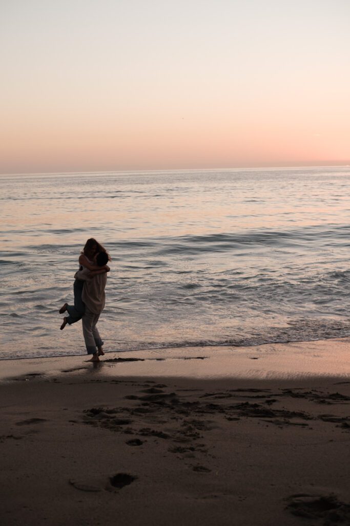 Lauren and Ben splashing in the shallow water during their Laguna Beach photo shoot