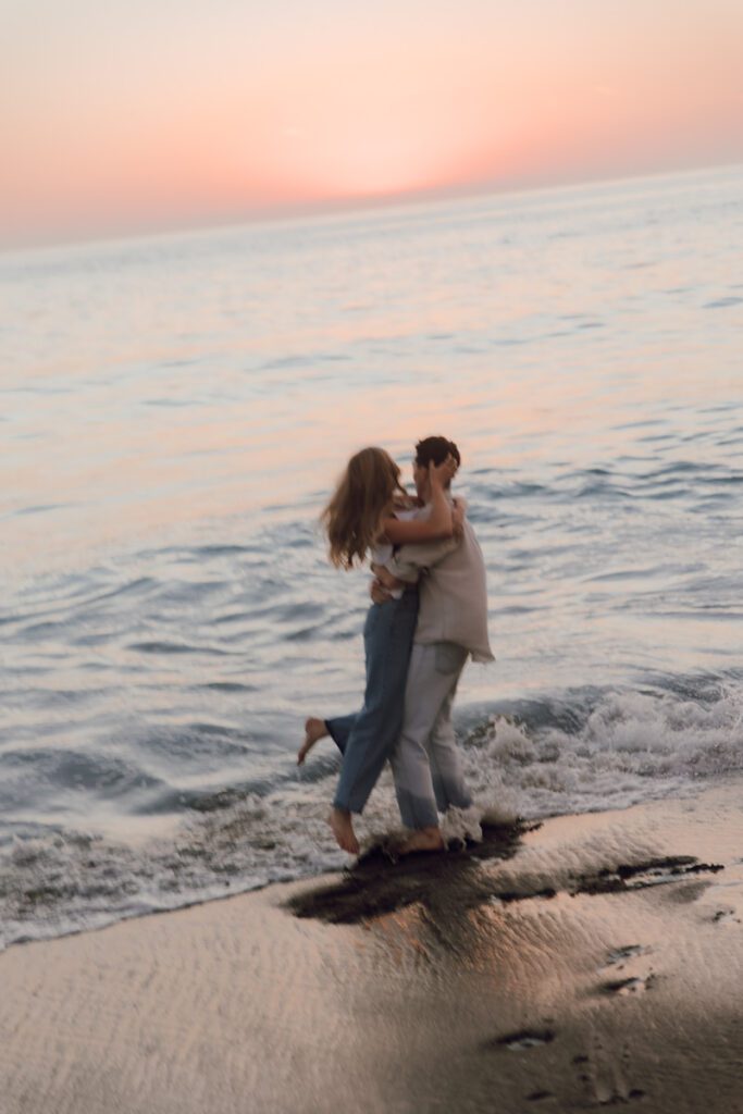 Lauren and Ben splashing in the shallow water during their Laguna Beach photo shoot