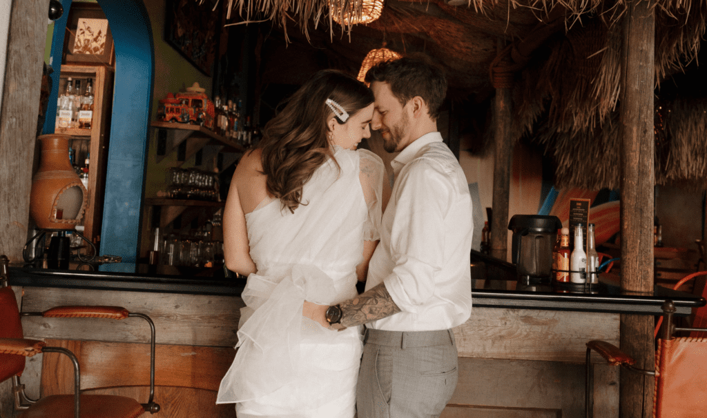 Chelsea and Michael laughing together during their engagement session at Las Palapas