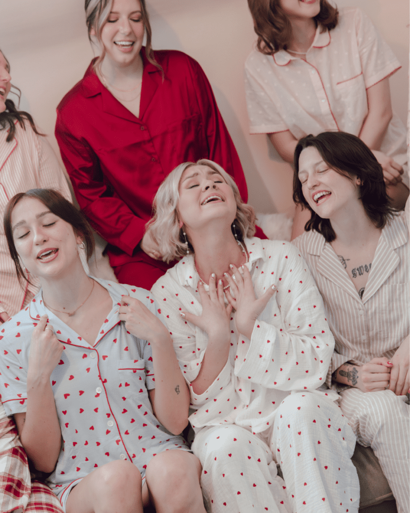 Bride getting ready with her bridesmaids in valentines themed pajamas