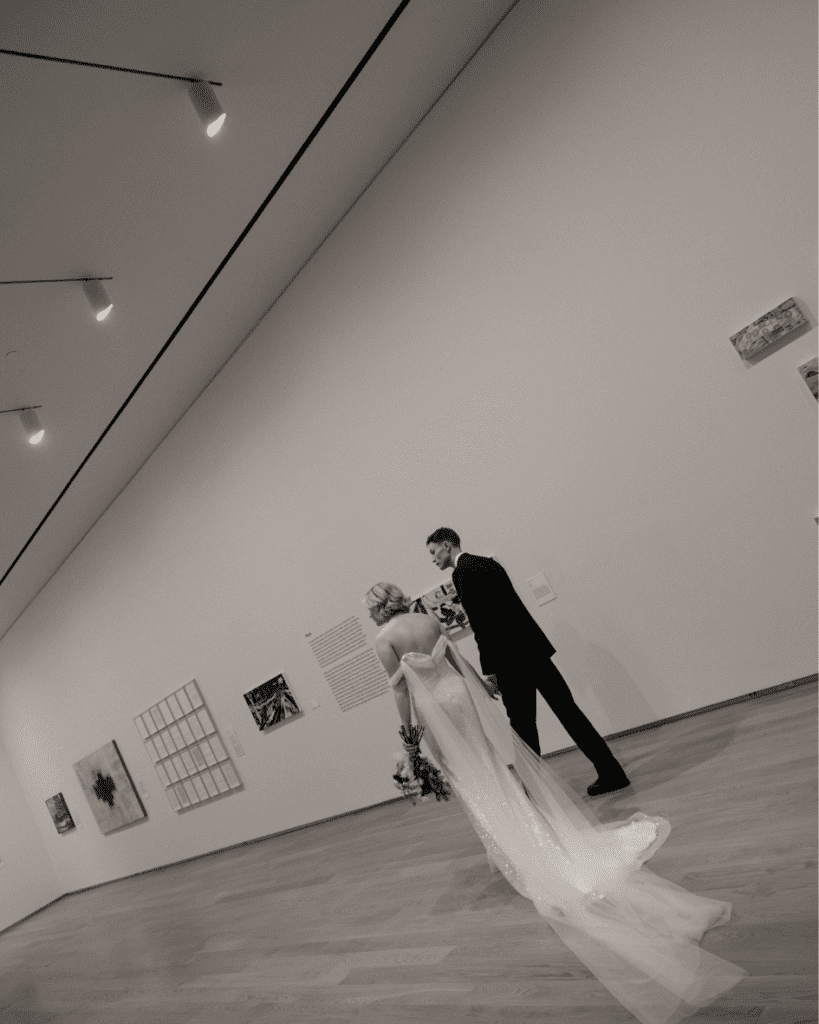 Bride and groom walking through the art installations during their wedding portraits