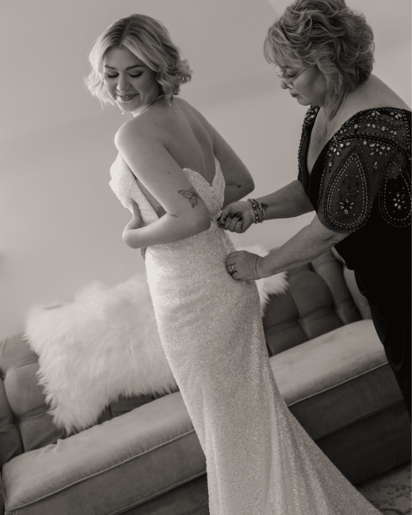 Brides mom helping her get into her Lis Simon gown