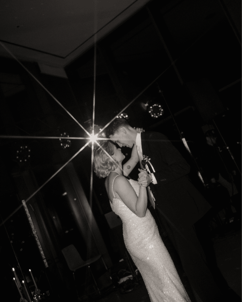 The couple dancing under disco balls on a packed dance floor at the Remai Modern.