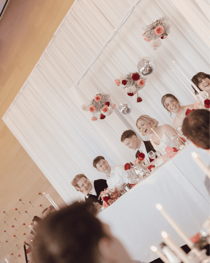 Guests toasting with cocktails during wedding speeches