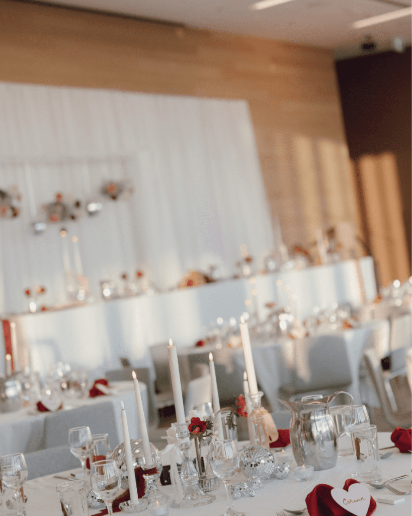 Valentine’s-inspired wedding table with custom matchboxes, disco balls, and pink floral centerpieces displayed for their remai modern wedding