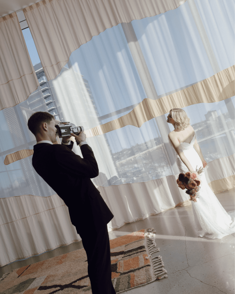 Bride and groom dancing in front of an art installation