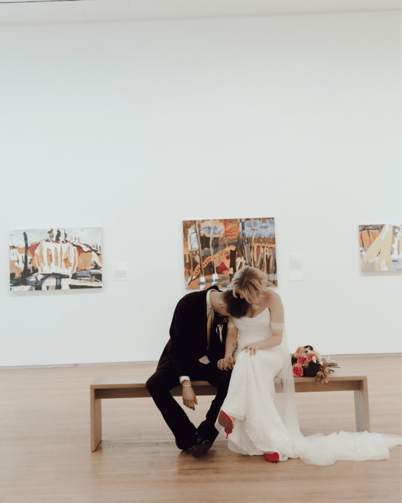 Bride and groom share a kiss under modern art installation at Remai Modern wedding