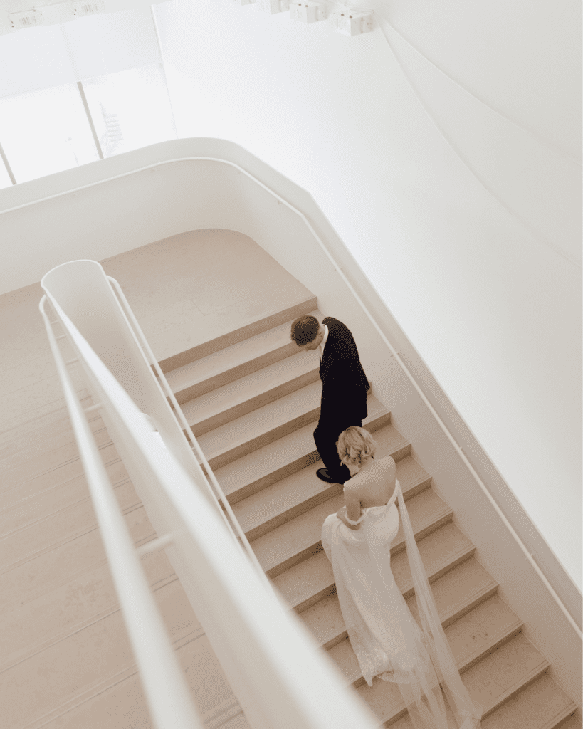 Bride and groom amongst art installations during their wedding portraits
