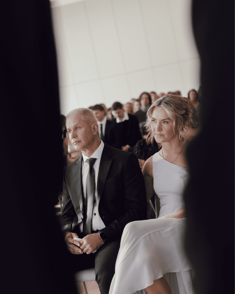 Grooms parents watching their son say his vows