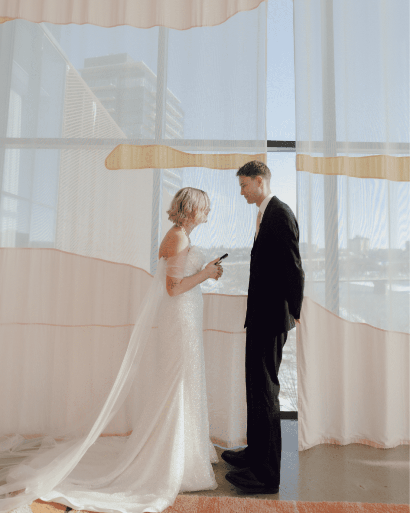 Bride and groom sharing a quiet moment among the art at Remai Modern during private vows