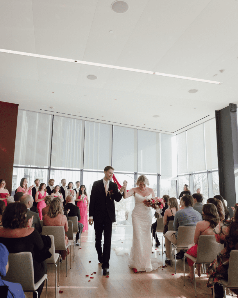 Bride and groom celebrating down the aisle after their ceremony