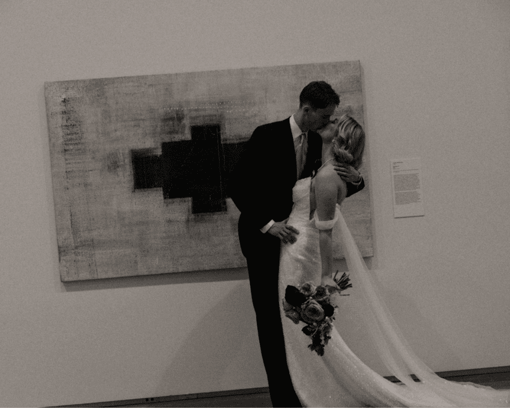 Bride and groom amongst art installations during their wedding portraits