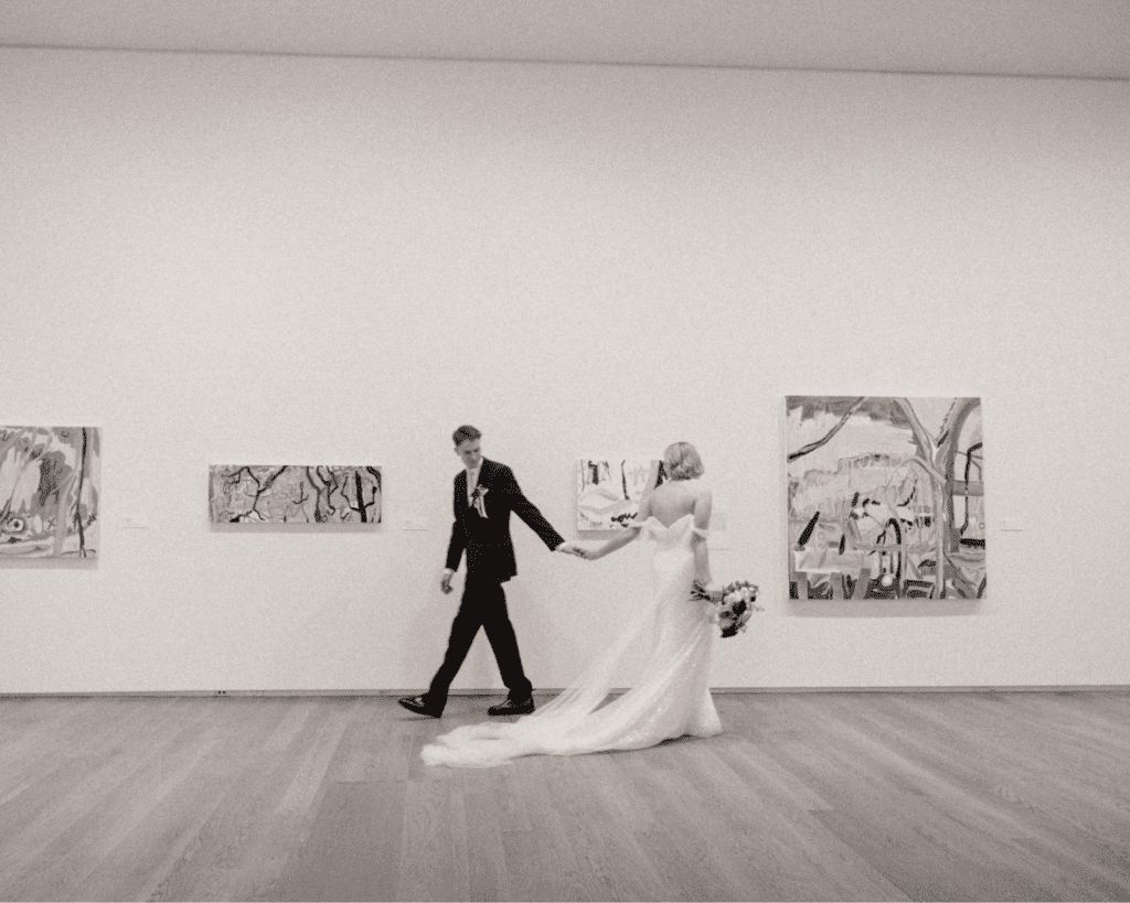 Bride and groom amongst art installations during their wedding portraits