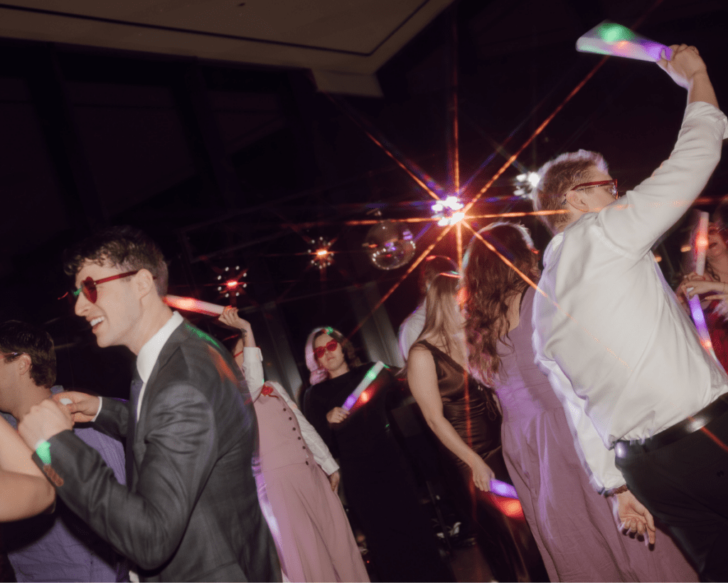 Packed dance floor with disco lights bouncing off the walls
