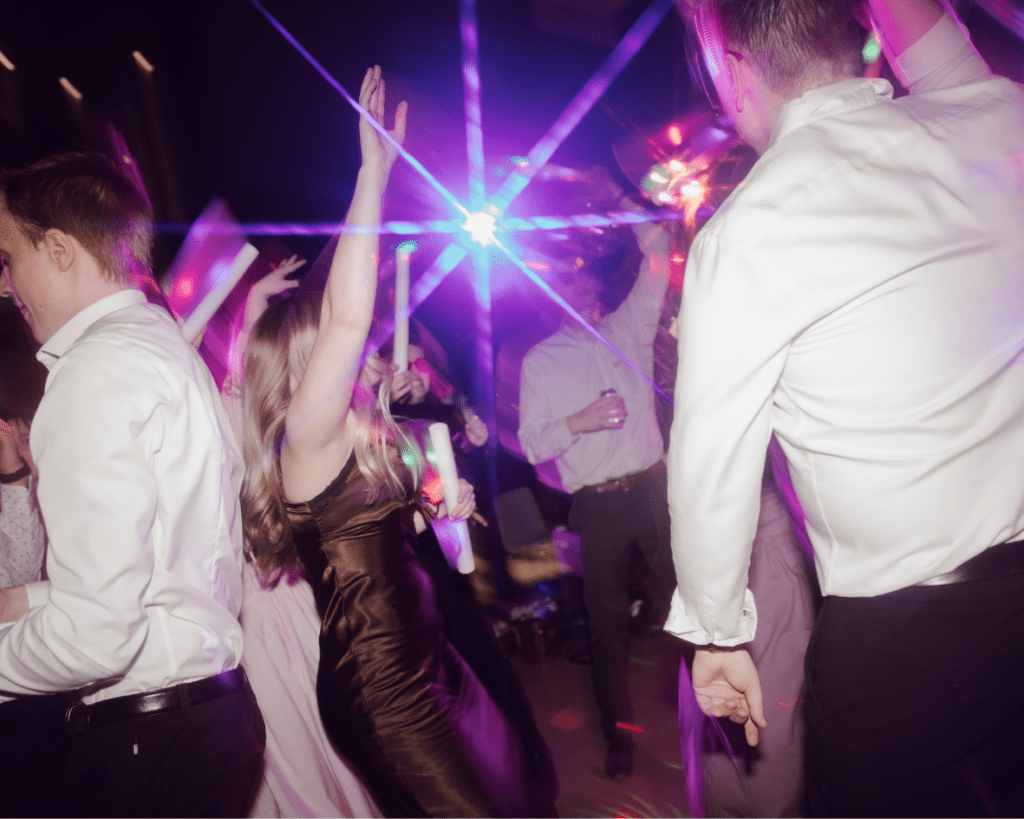 The couple dancing under disco balls on a packed dance floor at the Remai Modern.