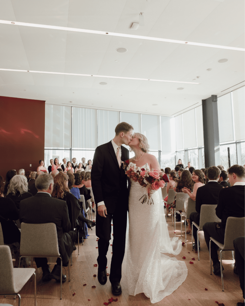 Bride and groom celebrating down the aisle after their remai modern wedding ceremony