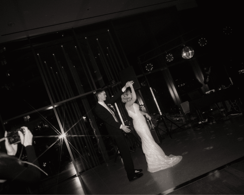 Bride spinning under disco balls during the first dance