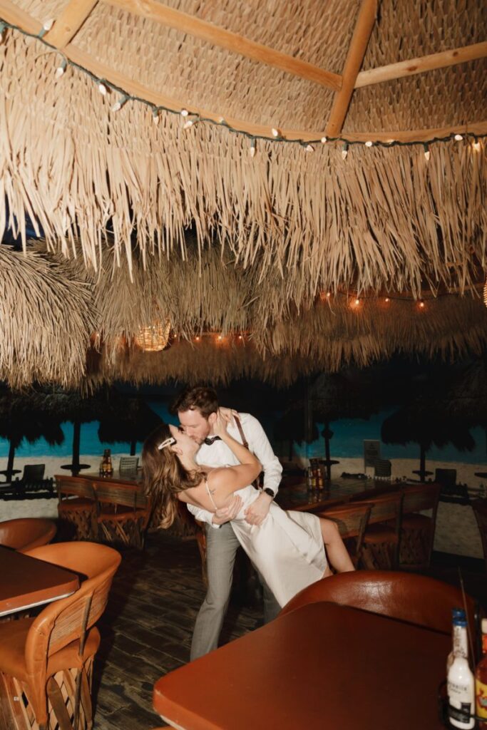 Chelsea and Michael laughing together during their engagement session at Las Palapas