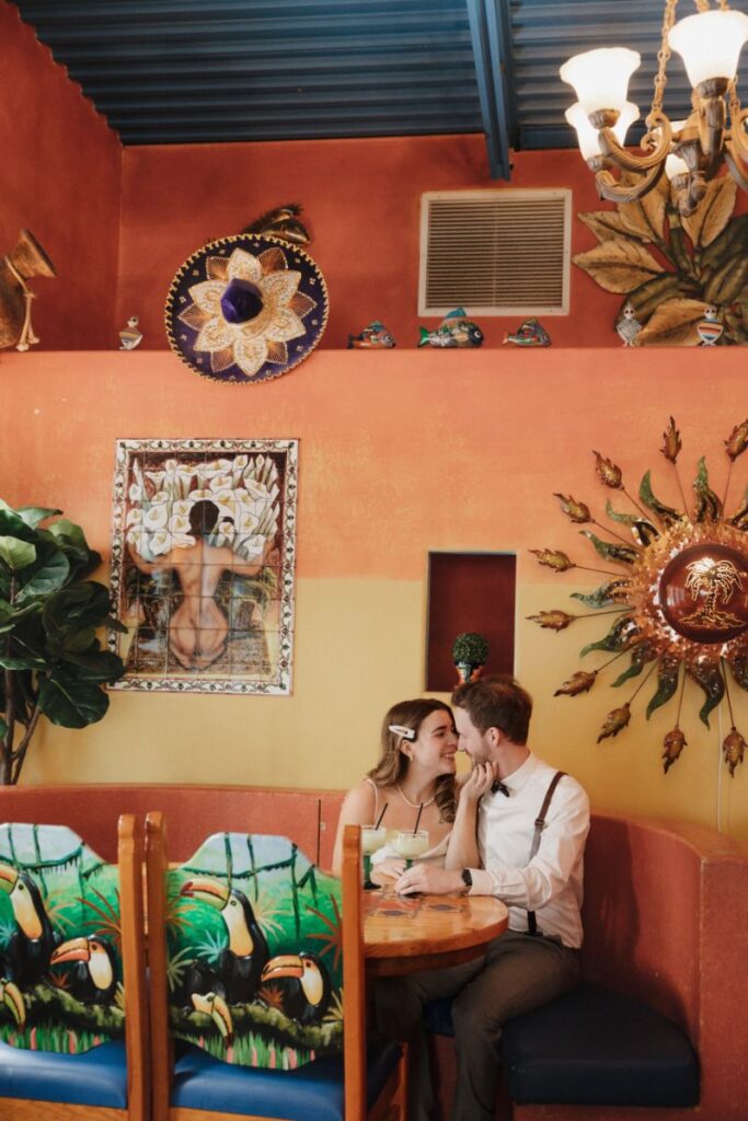 Chelsea and Michael laughing together during their engagement session at Las Palapas