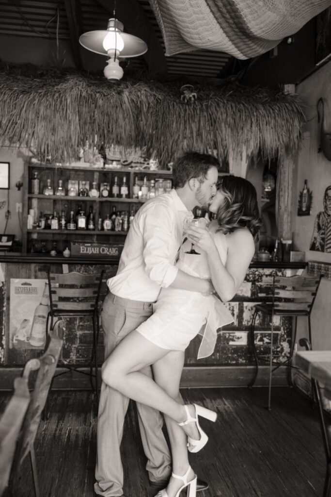 Chelsea and Michael laughing together during their engagement session at Las Palapas