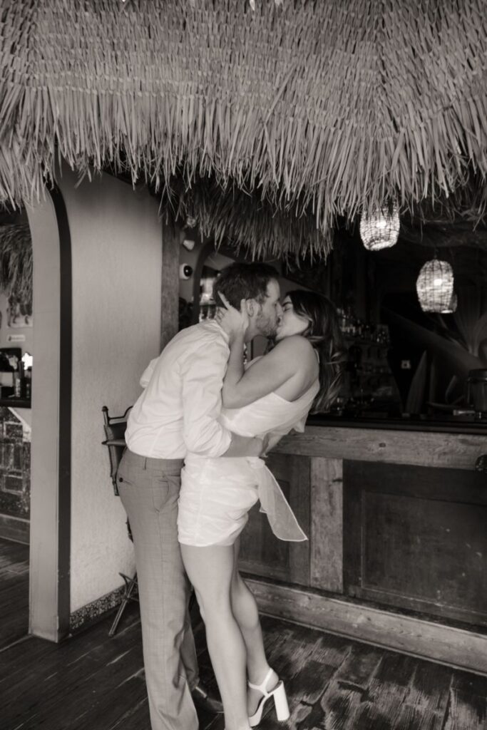 Chelsea and Michael laughing together during their engagement session at Las Palapas