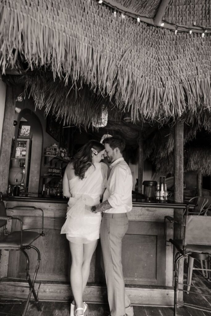 Chelsea and Michael laughing together during their engagement session at Las Palapas
