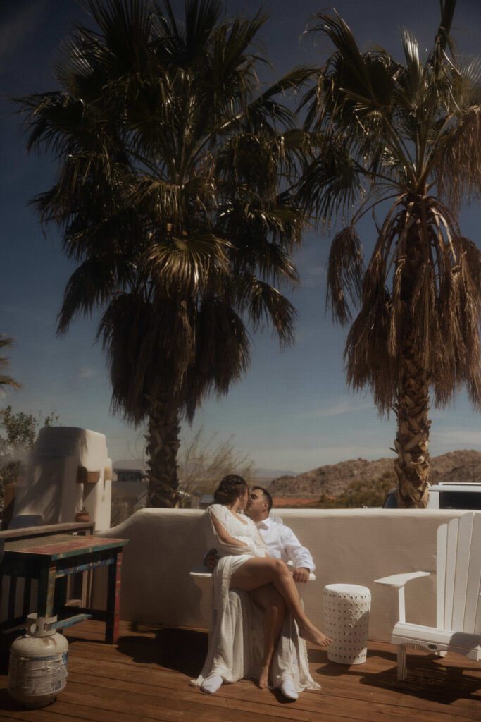 Bride and groom getting ready together in their Joshua Tree Airbnb before their elopement