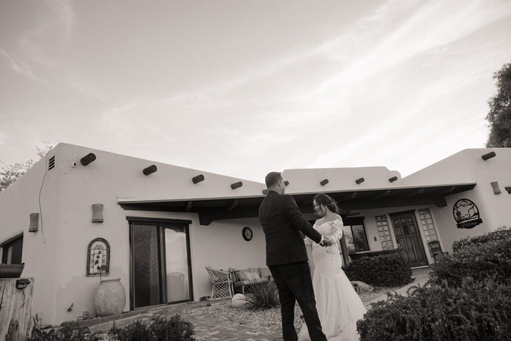 Couple’s first dance at sunset in the desert backyard of their Airbnb