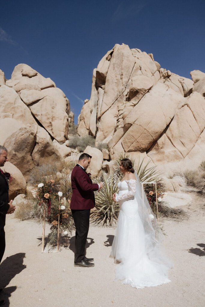 Bride smiling at groom during intimate wedding ceremony in Joshua Tree