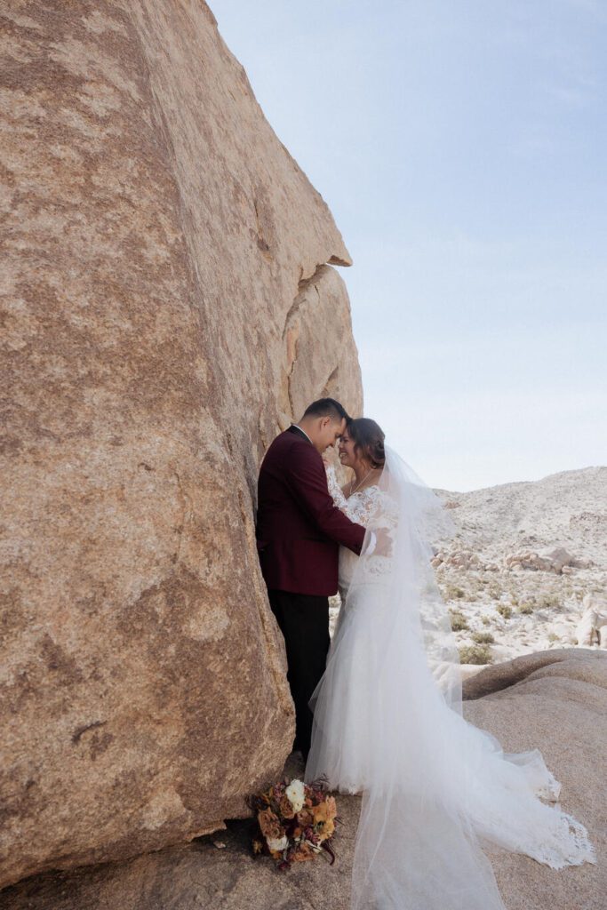 Bride’s veil blowing in the wind during romantic golden hour portraits
