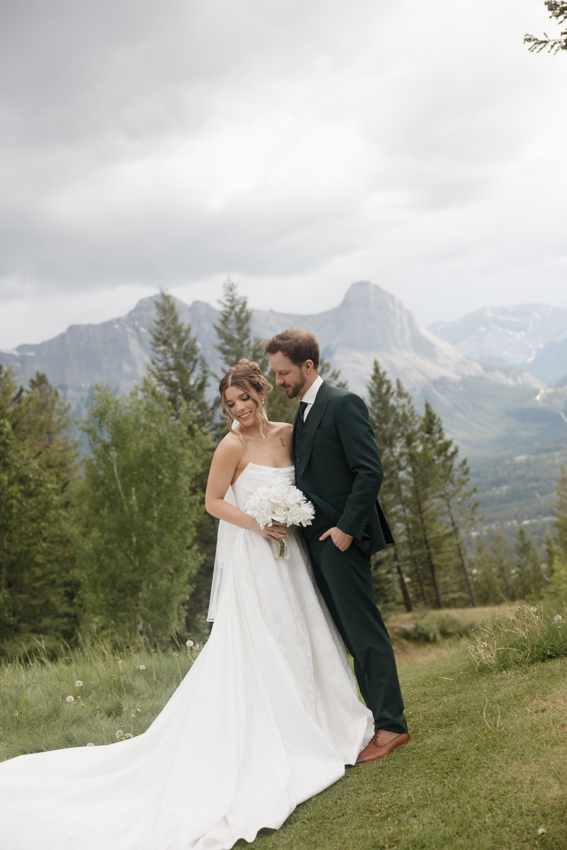 Mountain view wedding portraits with bride and groom smiling