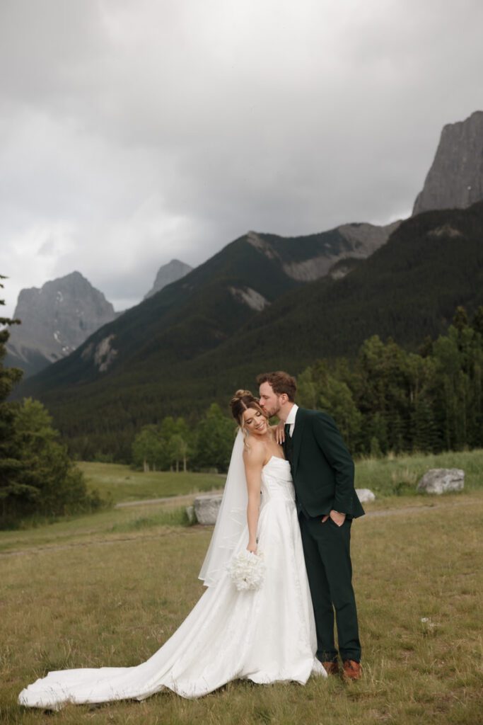 Mountain view wedding portraits with bride and groom smiling