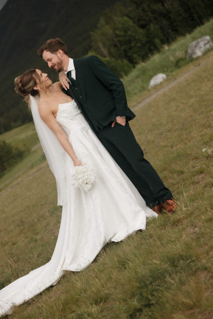 Mountain view wedding portraits with bride and groom smiling