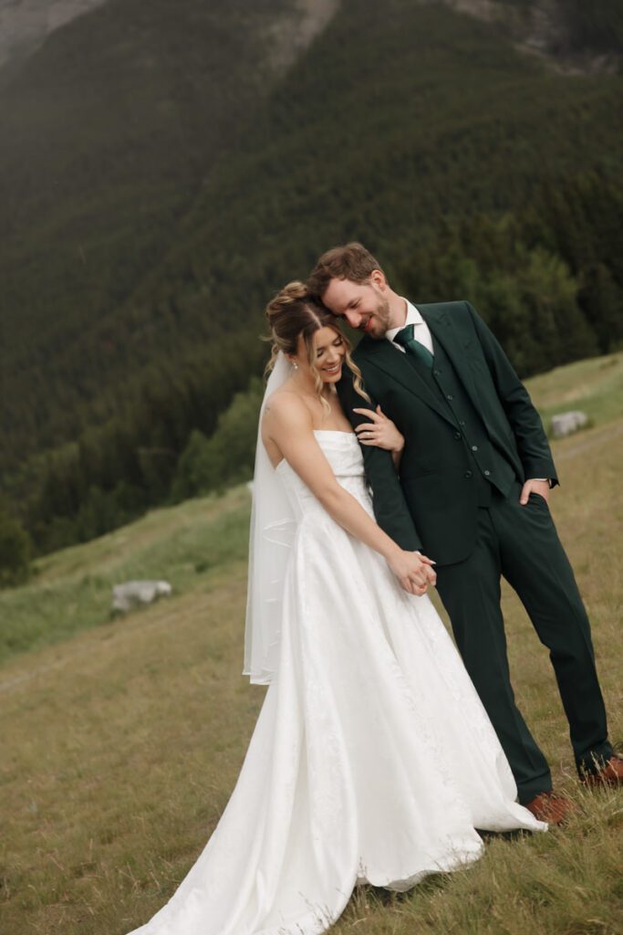 Mountain view wedding portraits with bride and groom smiling
