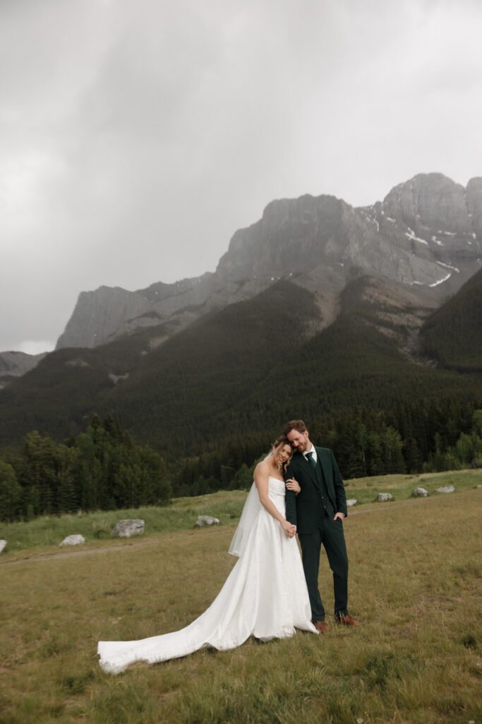 Mountain view wedding portraits with bride and groom smiling