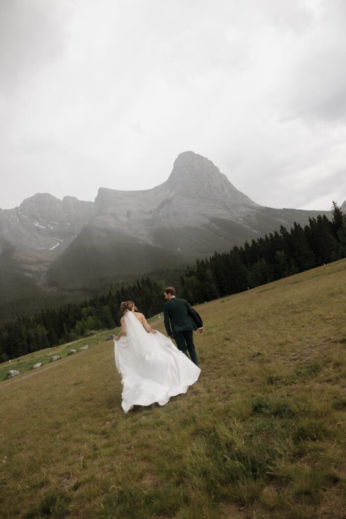 Mountain view wedding portraits with bride and groom smiling