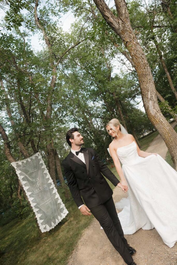 Bride and groom walking hand-in-hand across the Moon Lake golf course during their moon lake wedding photography