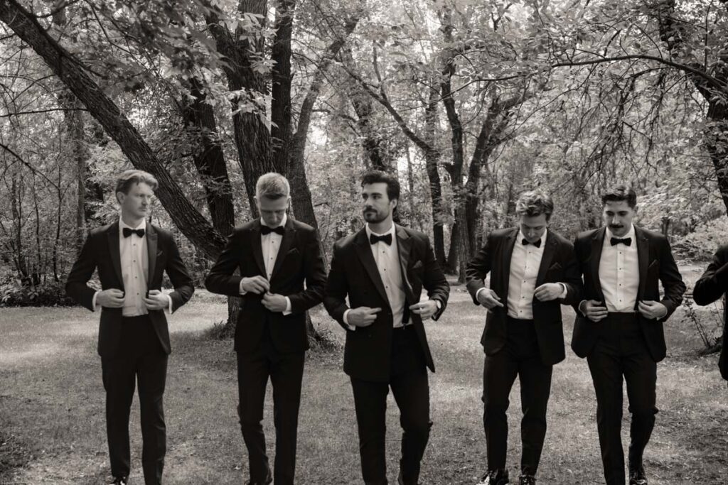 Groom with groomsmen all adjusting sunglasses, having fun in moon lake wedding photography