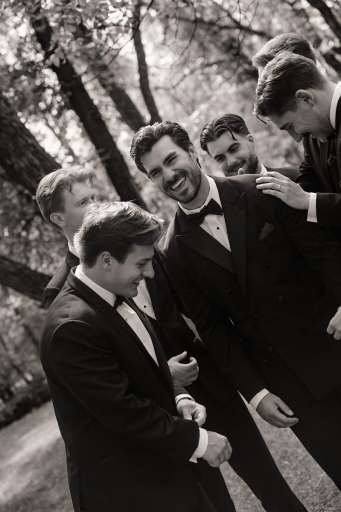 groom and his groomsmen having fun during moon lake wedding photography