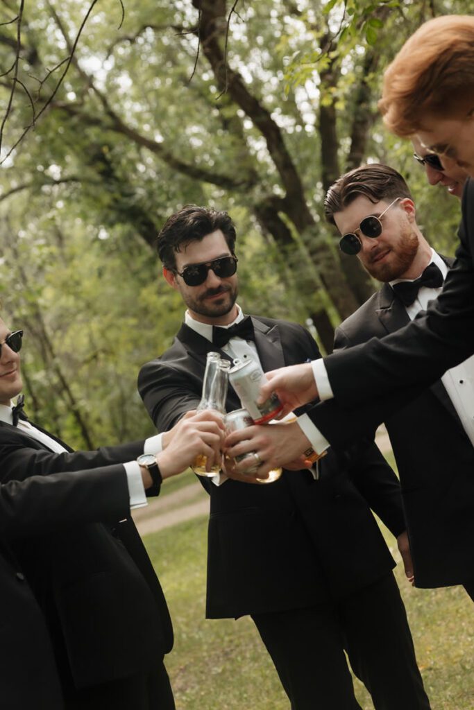 Groom with groomsmen all adjusting sunglasses, having fun in moon lake wedding photography