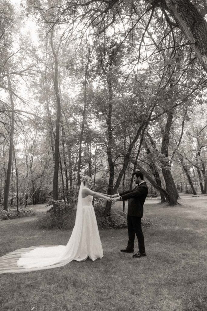 Intimate moment between bride and groom, hands clasped and eyes closed in moon lake wedding photography