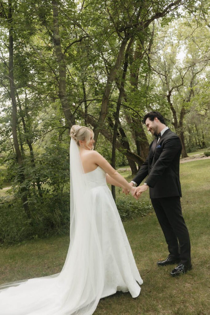Intimate moment between bride and groom, hands clasped and eyes closed