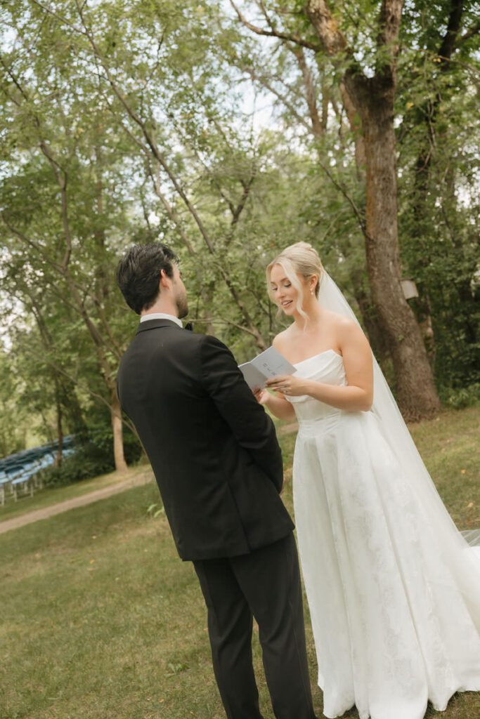 Couple exchanging private vows in an intimate wooded area