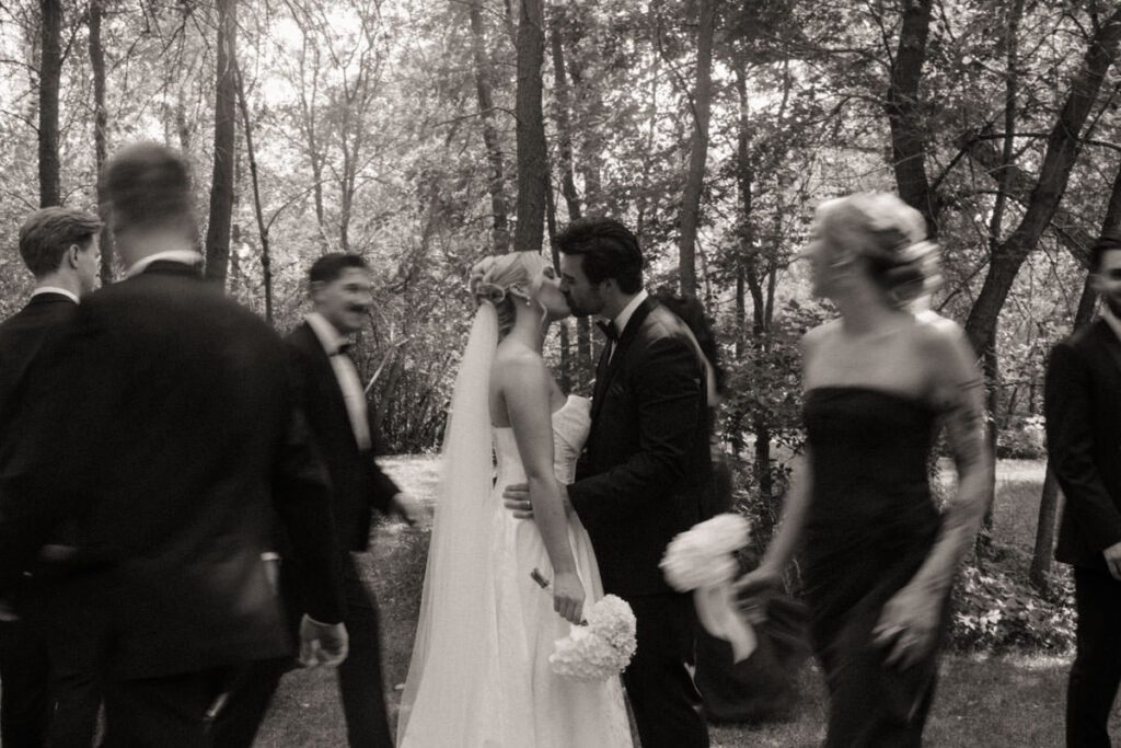 Group portrait of the wedding party walking together, all smiling in moon lake wedding photography