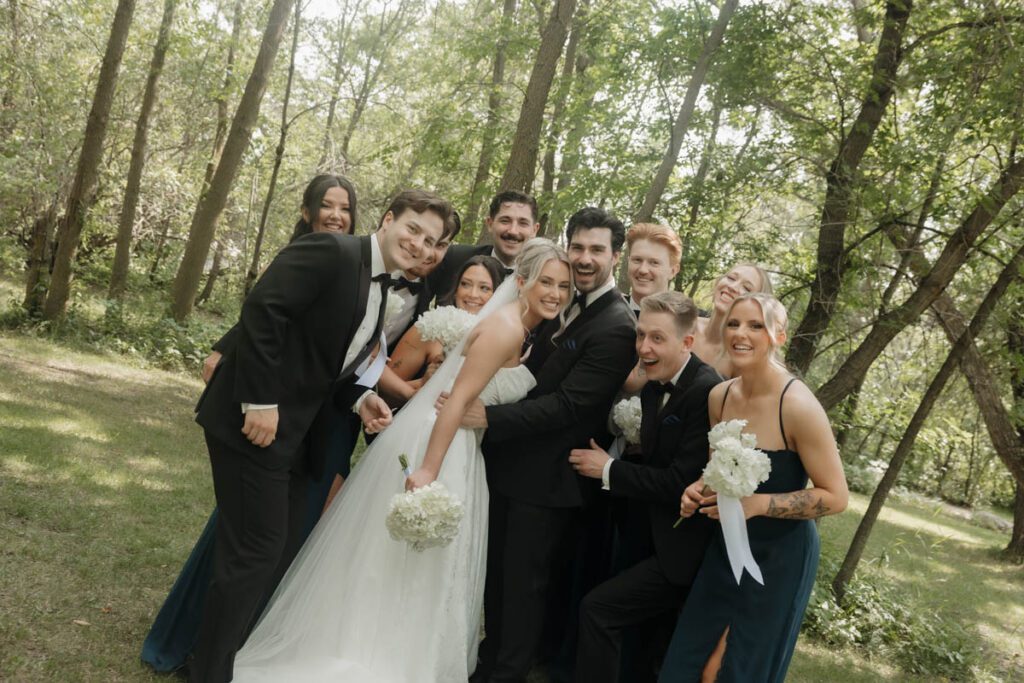 Group portrait of the wedding party walking together, all smiling in moon lake wedding photography