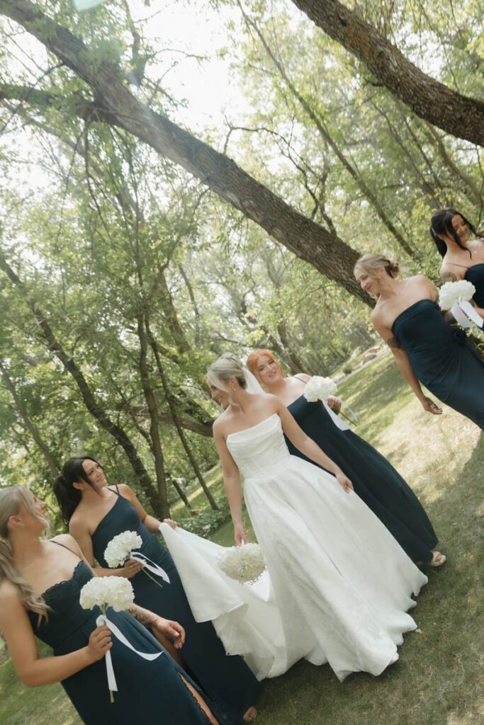 bride walking with her bridesmaids during moon lake wedding photography